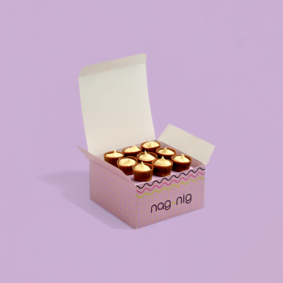 Box of chocolates with 'nag nig' branding on a light purple background