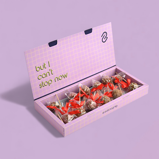 Pink gift box with chocolates and 'but I can't stop now' text on a purple background