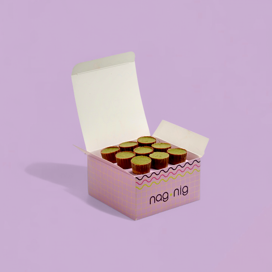Open box of Nag Nig products on a light purple background